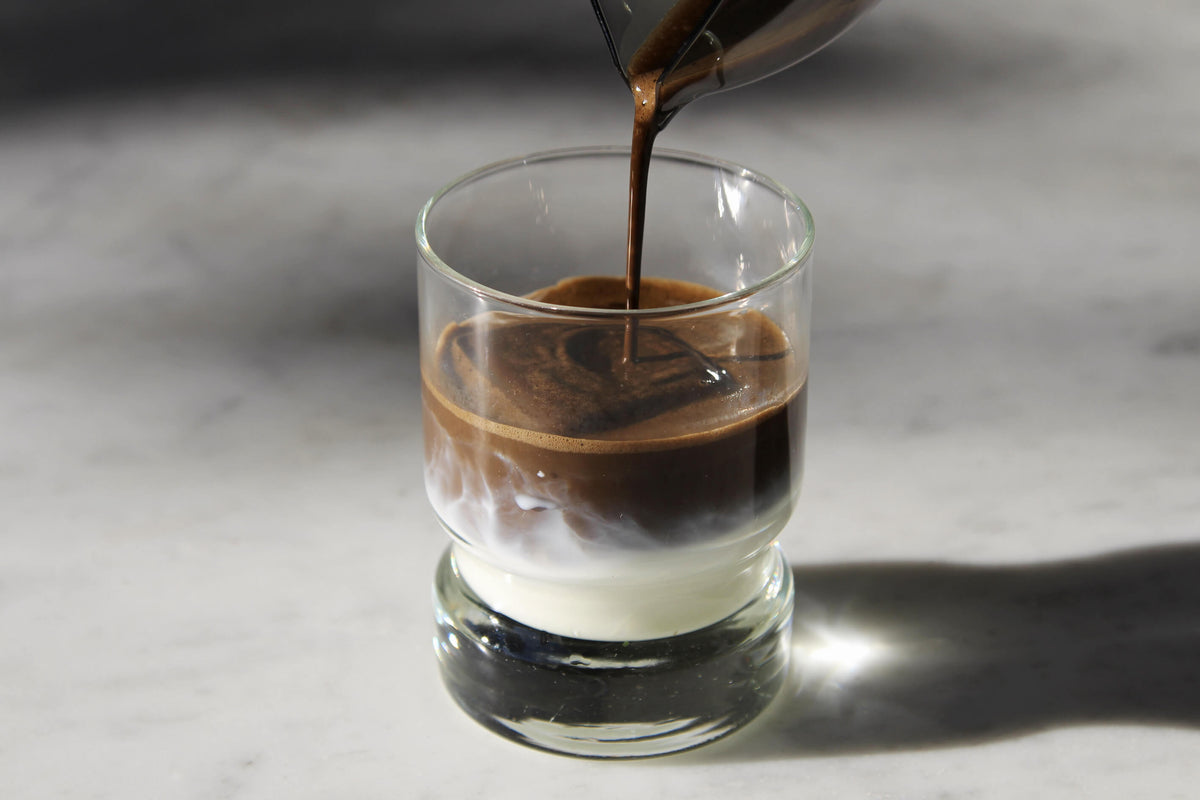 Higashiyama-en Shokoya Hojicha Latte being poured into vintage glass tumbler